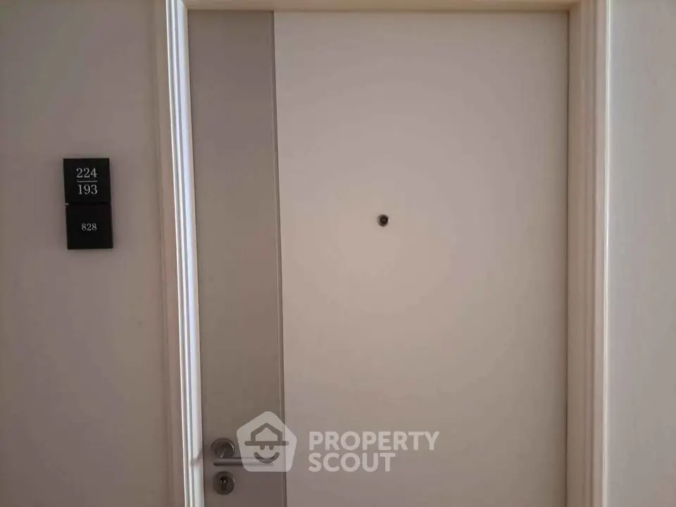 Modern apartment door with sleek handle and room number plaque, ideal for secure urban living.