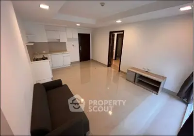 Modern apartment interior with open layout and sleek furnishings.