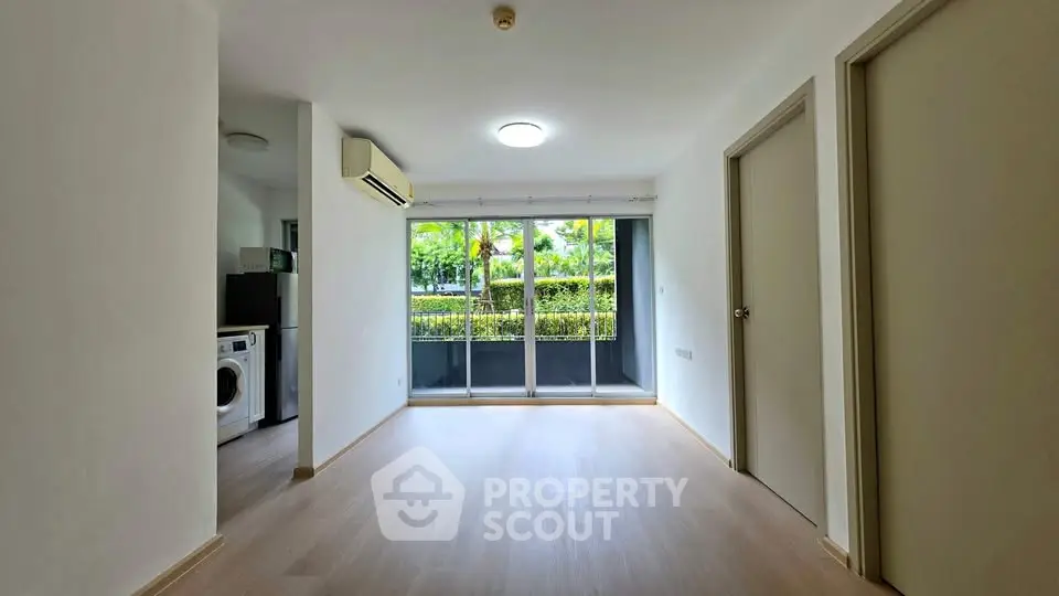 Spacious living room with large windows and garden view in modern apartment