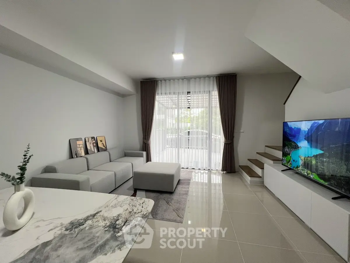 Modern living room with sleek design, large windows, and stylish furniture