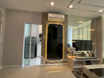 Modern living room with sleek design and stylish decor, featuring a wall-mounted TV and elegant lighting.