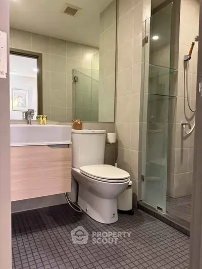 Modern bathroom with sleek design and glass shower enclosure.