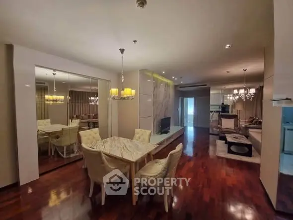 Luxurious open-plan living and dining area with elegant decor and hardwood floors.