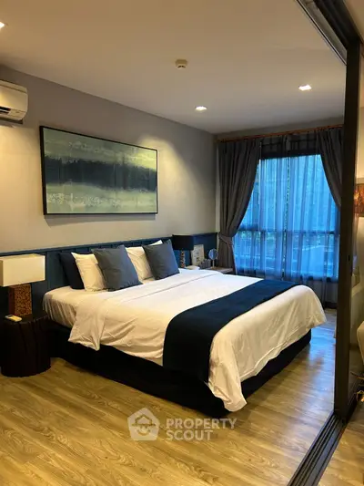 Elegant bedroom with modern decor and large window view