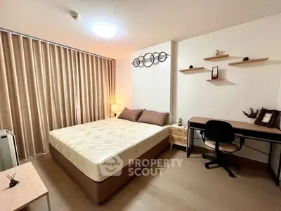 Cozy bedroom with modern decor and study area, perfect for relaxation and productivity.