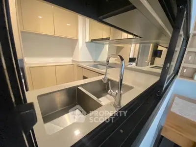 Modern kitchen with sleek cabinetry and double sink, perfect for culinary enthusiasts.