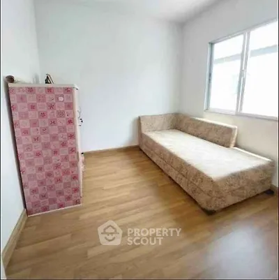 Cozy minimalist room with wooden flooring and natural light