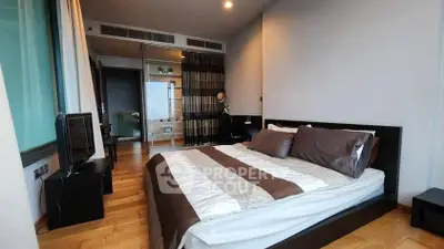 Spacious modern bedroom with wooden flooring and stylish decor