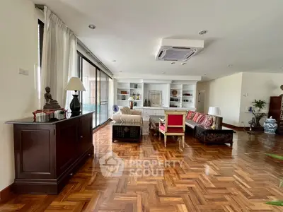 Spacious living room with elegant parquet flooring and stylish furniture