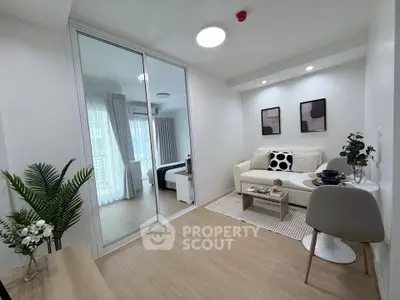 Modern living room with cozy decor and natural light in a stylish apartment.