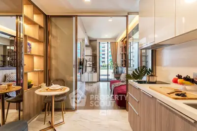 Modern open-plan kitchen and living area with stylish decor and natural light.