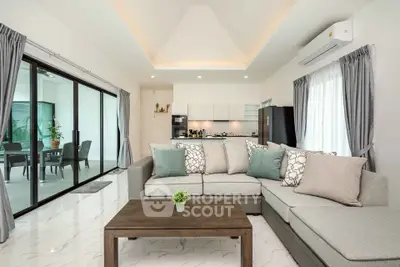 Spacious modern living room with elegant decor and open kitchen layout.