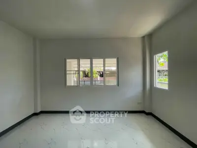 Spacious empty room with large windows and marble flooring, perfect for customization.