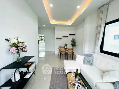 Modern living room with elegant decor, featuring a cozy white sofa, stylish dining area, and ambient lighting.