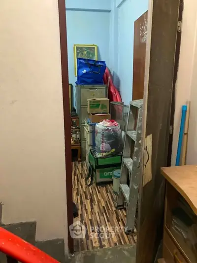 Compact storage room with shelves and various items, ideal for organizing household essentials.