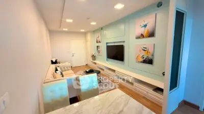 Modern living room with stylish decor and wall-mounted TV in a cozy apartment.