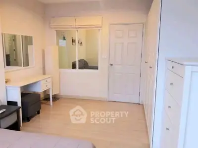 Spacious bedroom with modern furnishings and ample storage space