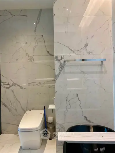 Luxurious marble bathroom with modern fixtures and elegant design.