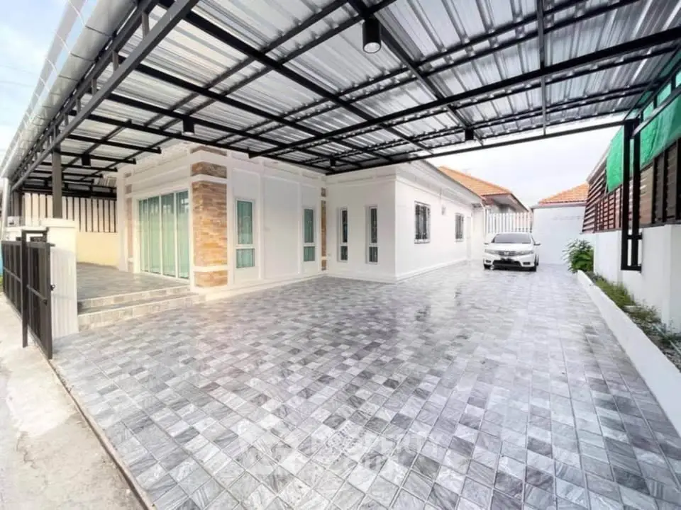 Spacious modern home with large driveway and covered parking area.