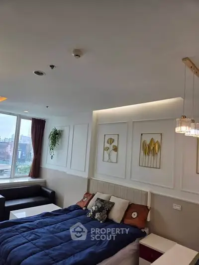 Modern bedroom with stylish decor and city view, featuring cozy bed and elegant lighting.
