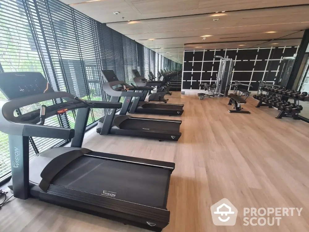 Modern gym with state-of-the-art equipment and floor-to-ceiling windows