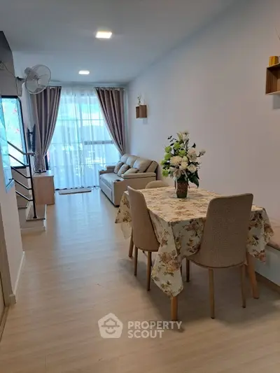 Charming living room with elegant decor and cozy seating area, perfect for relaxation and entertaining.