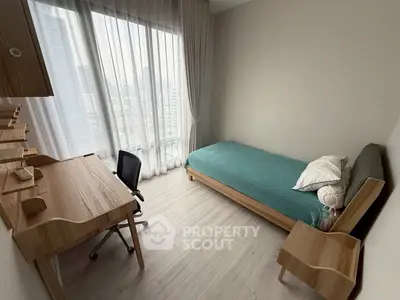 Modern minimalist bedroom with city view, featuring sleek wooden furniture and large window.