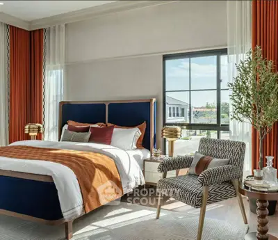 Luxurious bedroom with elegant decor and large window offering natural light