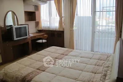 Cozy bedroom with large windows and elegant decor in a modern apartment.