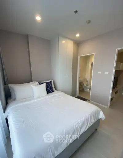Modern bedroom with ensuite bathroom in a stylish apartment