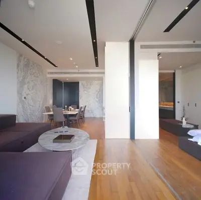 Luxurious open-plan living room with elegant dining area and modern decor