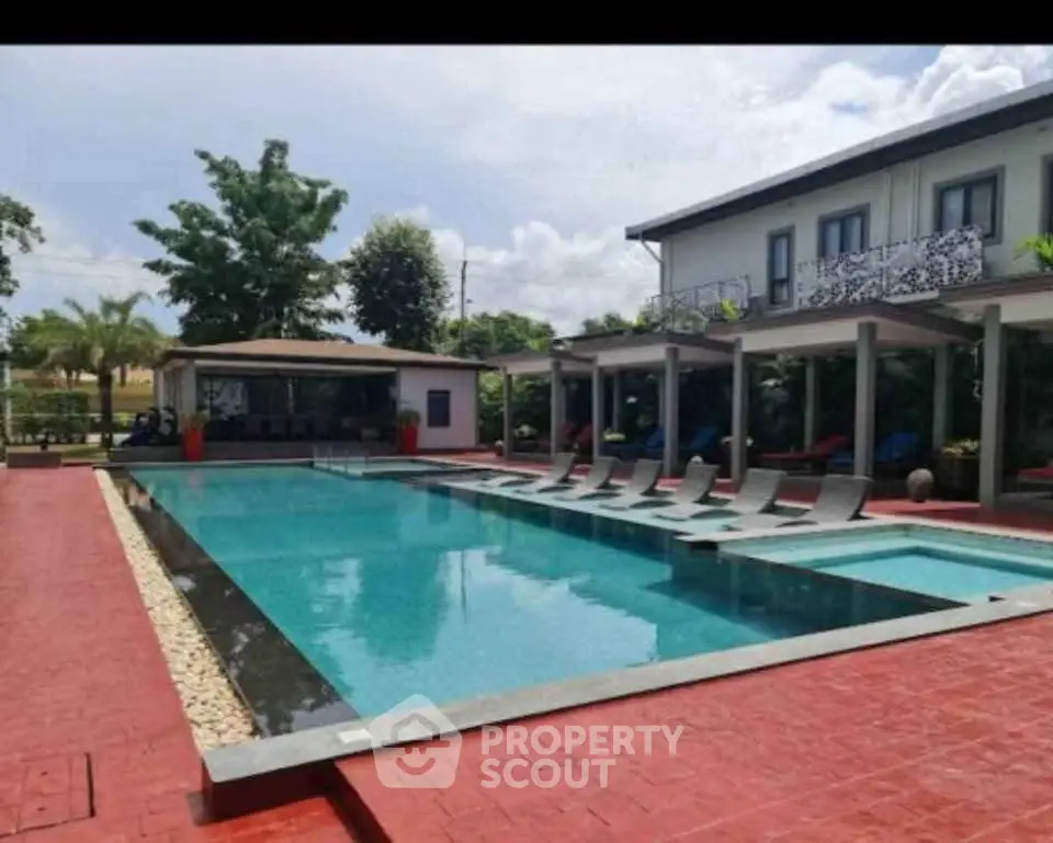 Luxurious poolside view with modern architecture and lush greenery