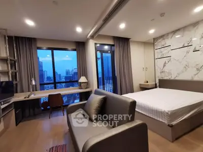 Modern studio apartment with city view, featuring stylish decor and open layout.