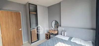 Modern bedroom with sleek wardrobe and stylish decor in a contemporary apartment.