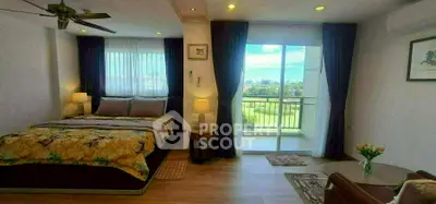 Spacious bedroom with balcony and scenic view, featuring modern decor and natural light.