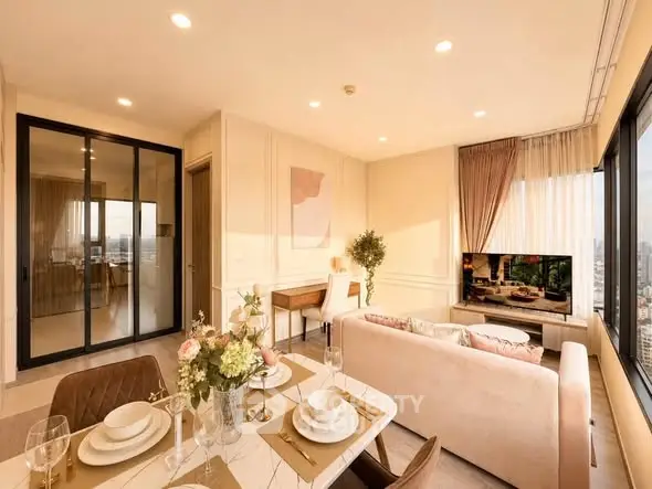 Luxurious living room with elegant decor and city view, featuring a cozy seating area and dining space.