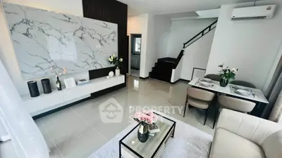 Modern living room with elegant decor and marble accent wall