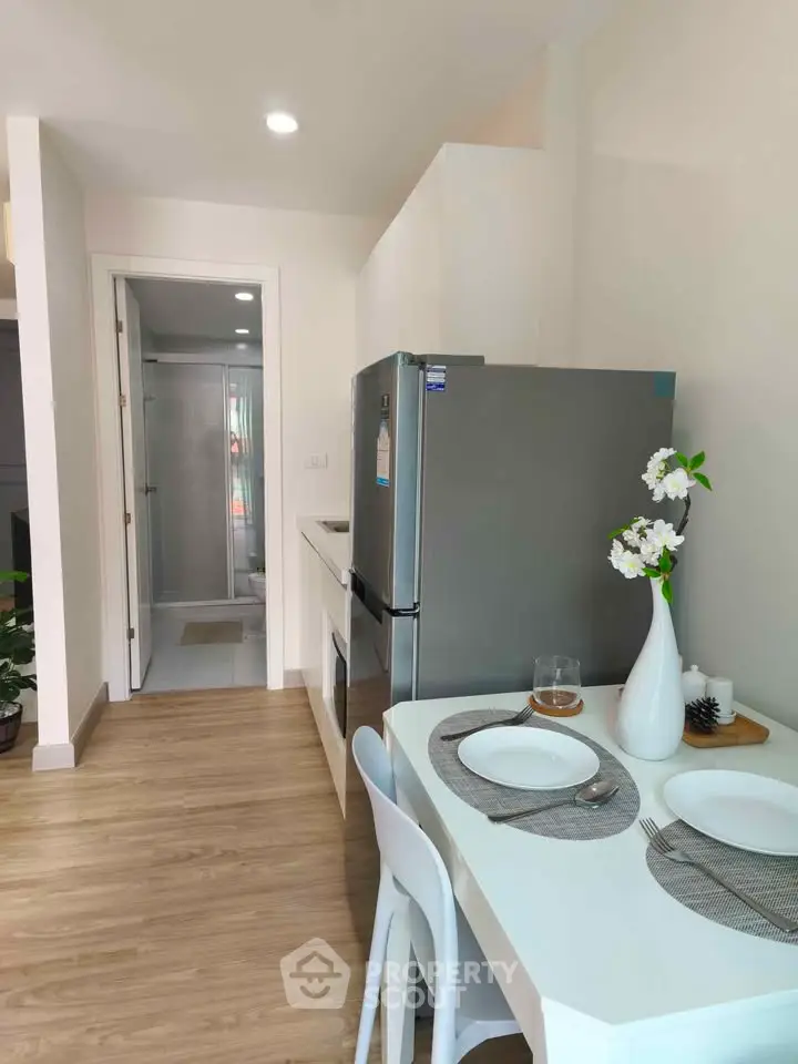 Modern kitchen with dining area featuring sleek appliances and elegant decor