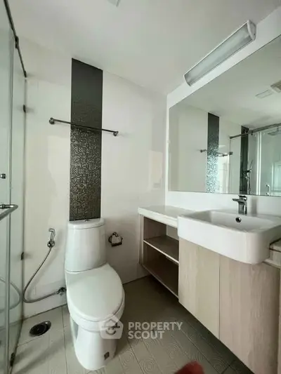 Modern bathroom with sleek fixtures and spacious shower area