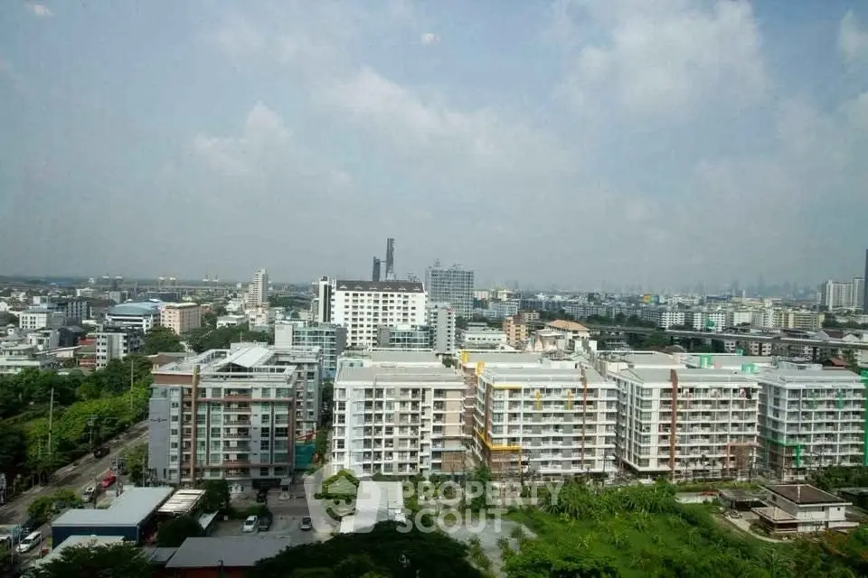 Panoramic cityscape view showcasing modern residential buildings and lush greenery.