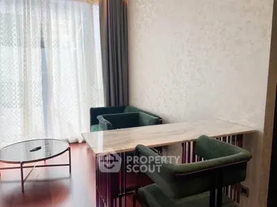 Modern living room with elegant marble table and stylish green chairs