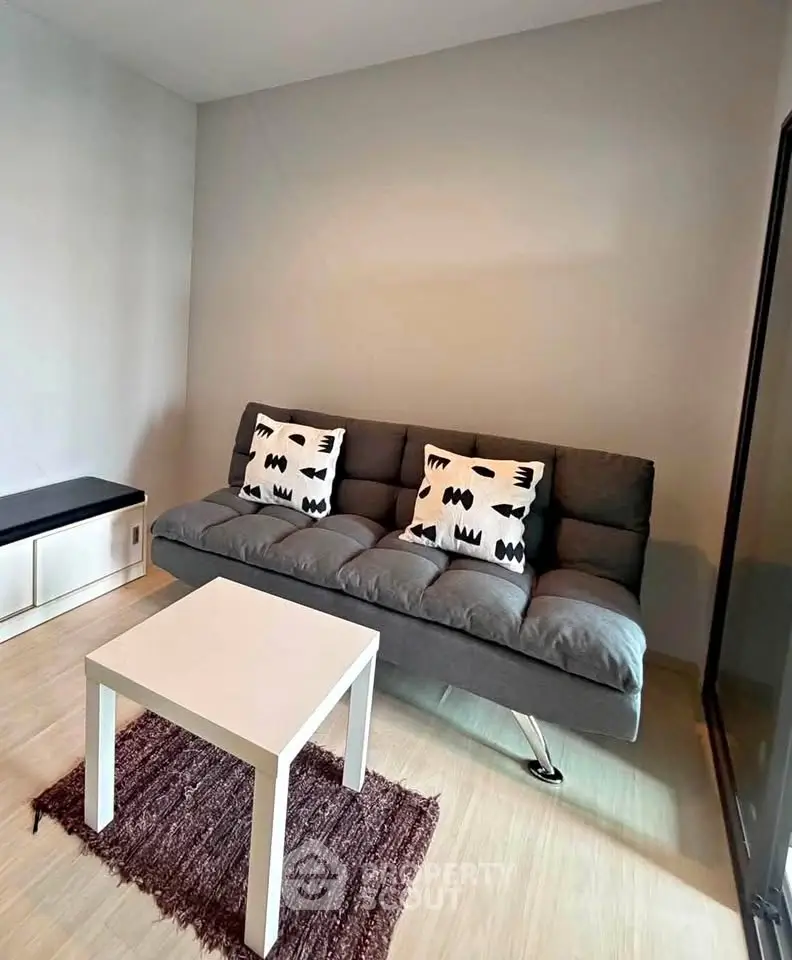 Modern living room with stylish gray sofa and minimalist decor