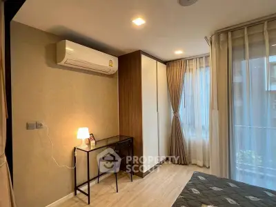 Cozy bedroom with modern decor, featuring a desk, wardrobe, and large window with curtains.