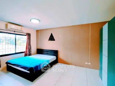 Spacious bedroom with modern decor and ample natural light