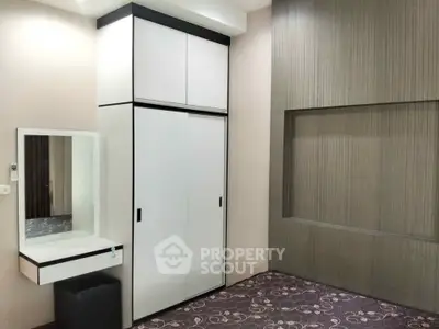 Modern bedroom with sleek wardrobe and stylish decor