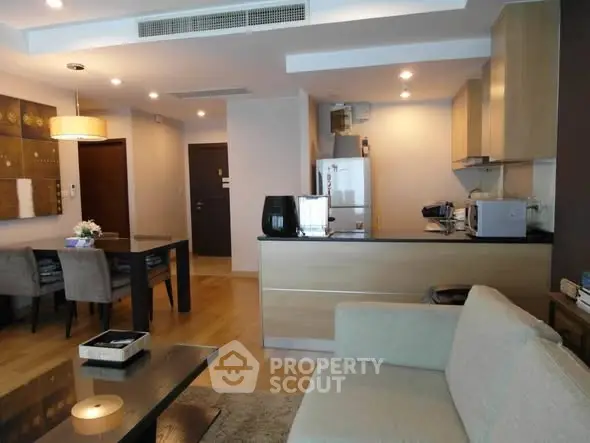 Modern open-plan living room and kitchen with stylish decor and dining area.