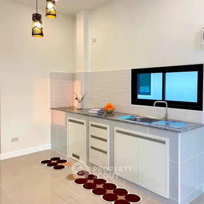 Modern kitchen with sleek cabinets and stylish lighting