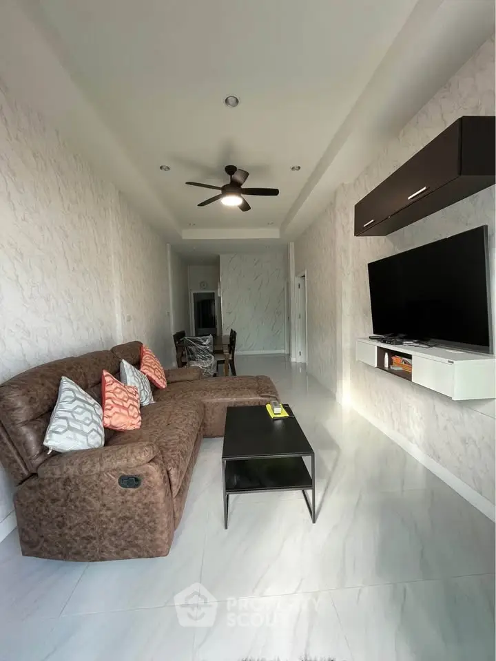 Modern living room with cozy sectional sofa and wall-mounted TV