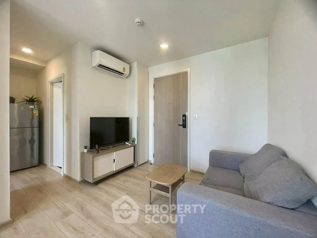 Modern living room with sleek furniture and air conditioning in a cozy apartment.