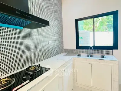 Modern kitchen with sleek gas stove and stylish backsplash tiles